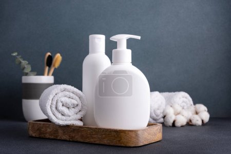 Photo for White empty shampoo or lotion bottle for mock-up in modern dark bathroom interior - Royalty Free Image
