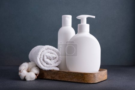 Photo for White empty shampoo or lotion bottle for mock-up in modern dark bathroom interior - Royalty Free Image