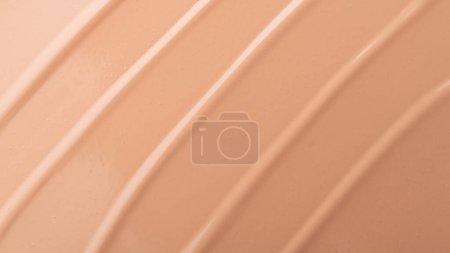 Delicate beige smeared texture of BB face cream, tonal foundation is smudged. Cosmetics products for makeup and skin care. 