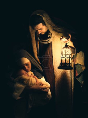 Photo for Proud parents during reenactment of a Christmas nativity scene with their own baby of 8 days old - Royalty Free Image