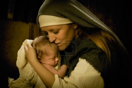 Photo for Live reenactment Christmas nativity scene of the real mother of an 8 days old baby boy playing Virgin Mary and baby Jesus - Royalty Free Image