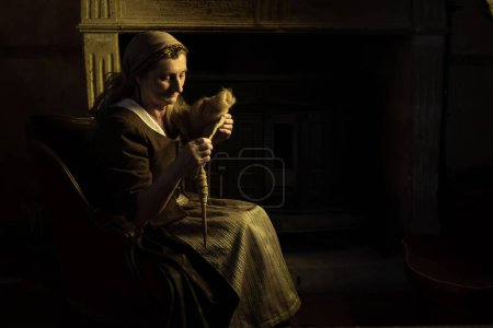 Photo for Woman spinning with a spindle - Royalty Free Image
