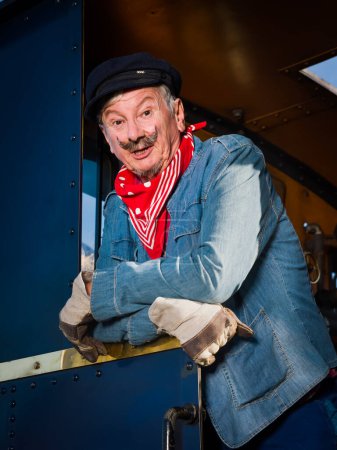 Reenactment scenes of a vintage worker or machinist in an authentic 1922 locomotive with restored engine