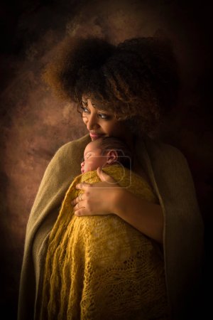 Beautiful African Ethiopian mother with newborn baby wearing a brown scarf on a brown background