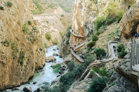 Photo for El Chorro, Spain, April 2023: People walking the Caminito Del Rey in the Desfiladero de los Gaitanes, a gorge carved by the Guadalhorce river in the province of Malaga, Spain - Royalty Free Image