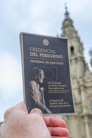 Photo for Santiago de Compostela, Spain, September 11th 2023: Illustrative Editorial: Close-up shot of Camino de Santiago pilgrim credential passport with cathedral in defocused background - Royalty Free Image