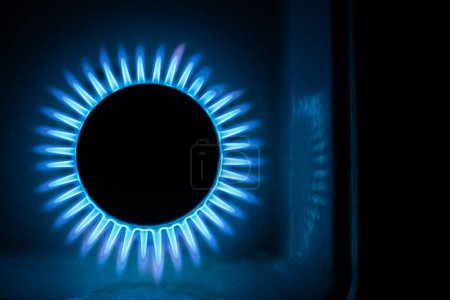 Photo for A hundred dollar bill on a gas burner with a burning fire on a black background, the front and back background is blurred with a bokeh effect - Royalty Free Image