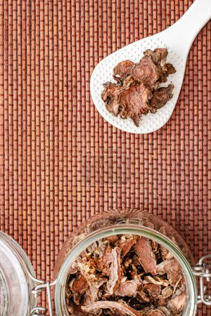 Photo for Dried chopped root of Rhoda rosea in a glass jar, used in rejuvenating the human body - Royalty Free Image