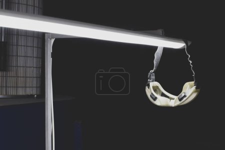Photo for Protective goggles for the eyes hanging on the luminaire in a hazardous production facility - Royalty Free Image