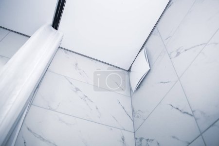 Photo for Fan in the shower closed with a beautiful decorative cover, diffuser and curtain in the bath - Royalty Free Image