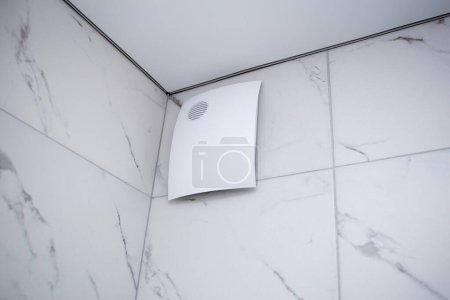 Photo for Fan in the shower closed with a beautiful decorative cover, diffuser and curtain in the bath - Royalty Free Image
