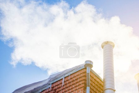 Photo for Metal chimney of a geothermal power station with stainless steel pipe structure with smoke and steam - Royalty Free Image