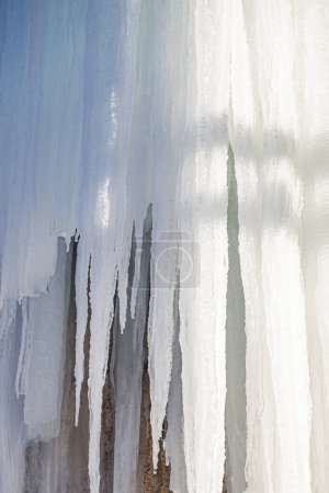 Photo for Icicles in the mountains close-up texture against a sunset background - Royalty Free Image
