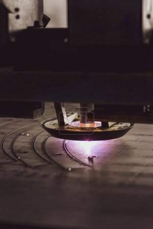 close-up laser cutting of metal on a CNC machine, at a large machine-tool plant in the center of the country