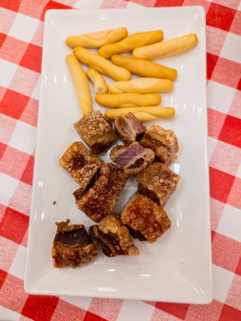 Photo for Pork, Tasty, Grilled, Gourmet, Typical Spanish dish called torreznos, consisting of deep-fried pork skin and savory fried crust - Royalty Free Image