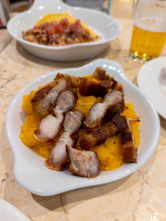 Photo for Cholesterol, Gourmet, Typical Spanish dish called torreznos, consisting of deep-fried pork skin and savory fried crust - Royalty Free Image