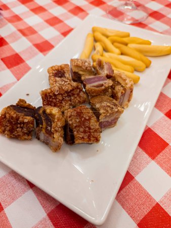 Photo for Pork, Tasty, Grilled, Gourmet, Typical Spanish dish called torreznos, consisting of deep-fried pork skin and savory fried crust - Royalty Free Image