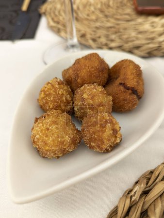 Photo for Typical Spanish dish called croquettes, they contain ham, or cooked or pork or cod, they can also contain mushrooms or whatever the cook wants - Royalty Free Image