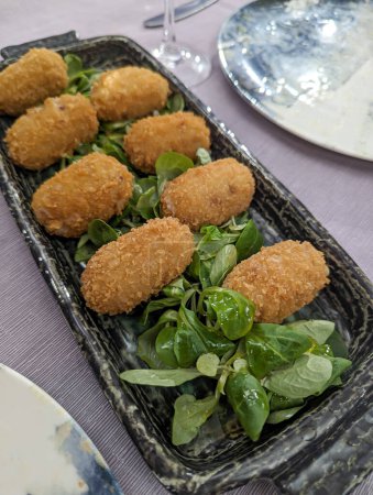 Photo for Savory Delights: Tempting Plate of Mushroom Croquettes, a Culinary Delight on a Restaurant Table, Perfect for Gourmet Food Enthusiasts and Gastronomic Adventures - Royalty Free Image
