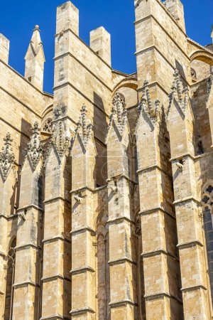 Photo for Let the detailed carvings, archways, and stonework of Mallorca cathedral's exterior lead you into a world of spiritual wonder and architectural mastery - Royalty Free Image