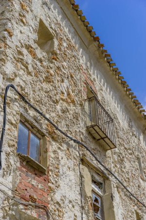 Photo for Sunlit rural streets, traditional houses lining up, the essence of historic Spain captured - Royalty Free Image