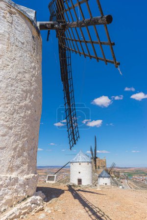 Photo for Hilltop windmills, silhouette against the Spanish sky. Toledo's history, culture, and scenic beauty intertwined in one frame - Royalty Free Image