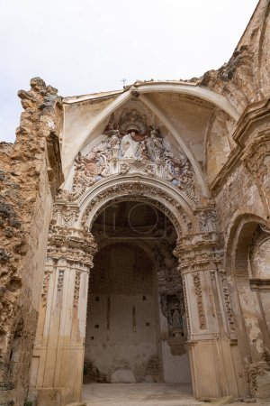 Photo for A vertical shot capturing the intricate facade of the weathered ruins of the Monasterio de Piedra's church against a cloudy sky. - Royalty Free Image