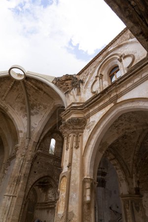 Téléchargez les photos : Un plan vertical capturant la façade complexe des ruines altérées de l'église du Monasterio de Piedra contre un ciel nuageux. - en image libre de droit
