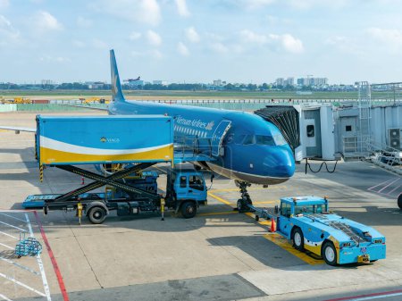 Photo for Ho Chi Minh City, Vietnam - April 13th 2018: Vietnam Airlines Airbus A321 getting supplies from a food truck at Tan Son Nhat Airport in Ho Chi Minh City, Vietnam. - Royalty Free Image