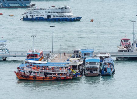Photo for Pattaya, Thailand - August 22nd 2023: Tourist boats waiting for passengers at Bali Hai Pier in Pattaya. The boats take tourists to Koh Lan and other tropical island off the coast of Pattaya. - Royalty Free Image