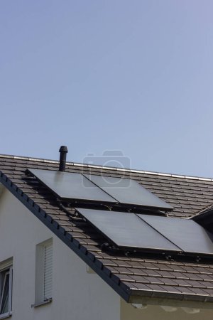 Photo for Solar panel rooftop on building roof with construction scaffold in south germany sunny spring day - Royalty Free Image