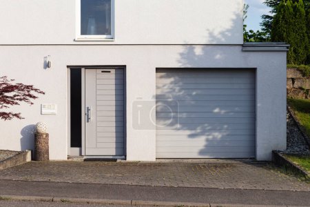 Foto de Garaje cochera en una moderna fachada de casa en el sur de Alemania ciudad al sol de verano y el cielo azul - Imagen libre de derechos