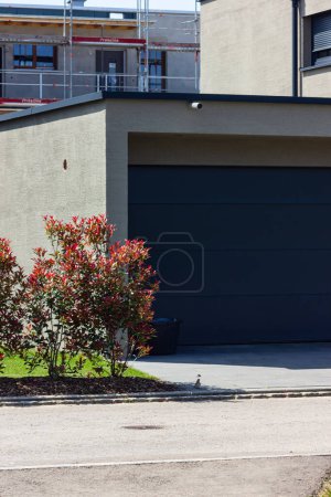 Photo for Garage carport on a modern house facade in south germany city at summer sunshine and blue sky - Royalty Free Image