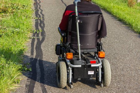 Photo for Wheel chair with motor beside a road in summertime in germany - Royalty Free Image