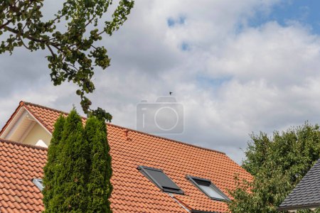 Photo for Roof window on a new building rooftop in september sunny day in south germany - Royalty Free Image