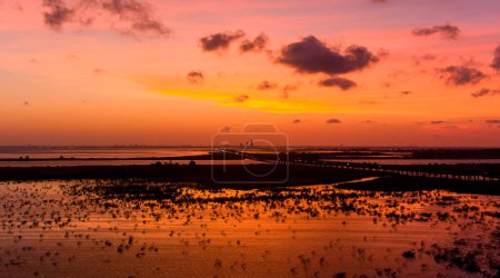 Drone photography of a dramatic sky at sunset over Mobile Bay on the Alabama Gulf Coast