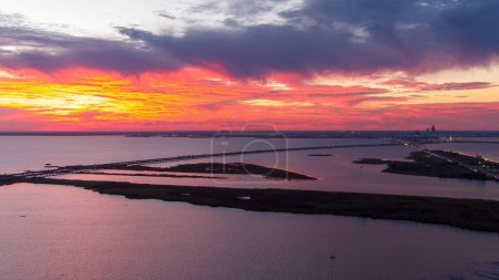 Photo for Aerial view of the Mobile Bay causeway and the Jubilee Parkway bridge at sunset on the Alabama Gulf Coast - Royalty Free Image