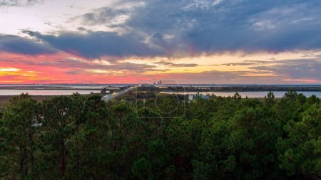 Photo for Aerial view of the Mobile, Alabama skyline visible from the eastern shore of Mobile Bay at sunset - Royalty Free Image