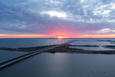 Aerial view of Jubilee Parkway and Mobile Bay at sunset in April on the Alabama Gulf Coast