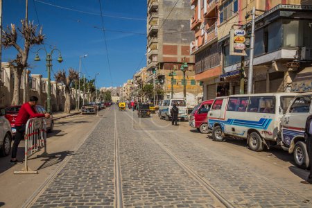Photo for ALEXANDRIA, EGYPT - FEBRUARY 2, 2019: Street with tram tracks in Alexandria, Egypt - Royalty Free Image