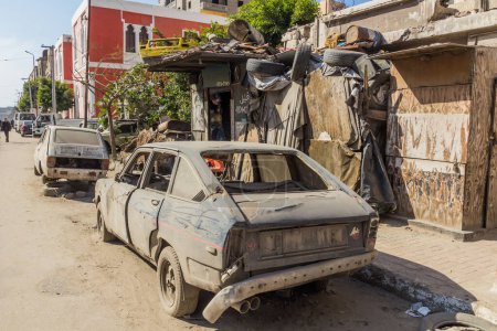 Téléchargez les photos : ALEXANDRIA, EGYPT - FEBRUARY 2, 2019: Wrecked old cars on a street in Alexandria, Egypt - en image libre de droit