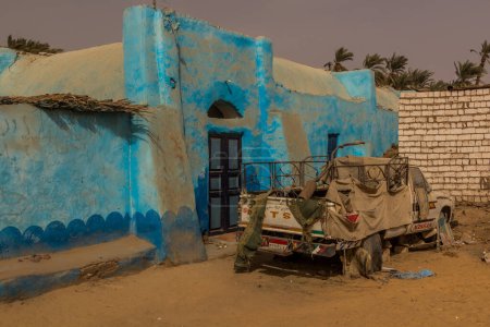 Photo for ASWAN, EGYPT: FEB 15, 2019: Old truck in a colorful Nubian village near Aswan, Egypt - Royalty Free Image