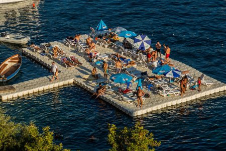 Photo for OHRID, NORTH MACEDONIA - AUGUST 7, 2019: Aerial view of bathing and sunbathing floating platform in Ohrid town, North Macedonia - Royalty Free Image