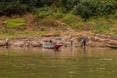 Photo for HAT SA, LAOS - NOVEMBER 23, 2019: Boats at Nam Ou river in Hat Sa village in Phongsali province, Laos - Royalty Free Image