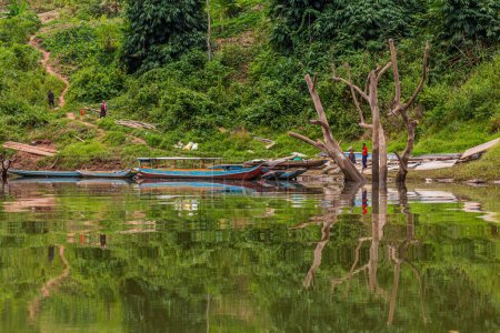Photo for NAM OU, LAOS - NOVEMBER 23, 2019: Boats at Nam Ou river in Phongsali province, Laos - Royalty Free Image