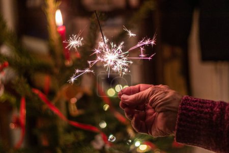 Photo for Hand holding a Christmas sparkler - Royalty Free Image