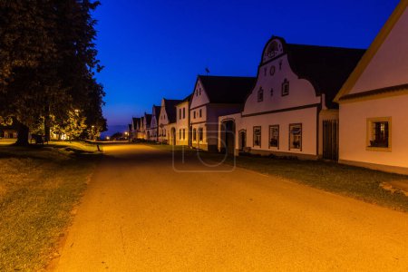 Photo for Evening view of traditional houses of rural baroque style in Holasovice village, Czech Republic - Royalty Free Image