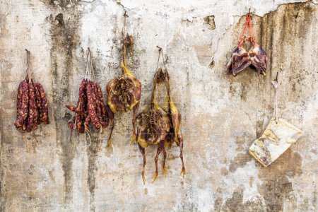 Photo for Ducks, fish and sausages hanging on a wall in Xidi village, Anhui province, China - Royalty Free Image