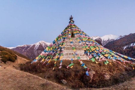 Photo for Stupa with prayer flags in Haizi valley near Siguniang mountain in Sichuan province, China - Royalty Free Image