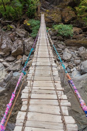 Photo for Hanging foot bridge over Jinsha river in Tiger Leaping Gorge, Yunnan province, China - Royalty Free Image